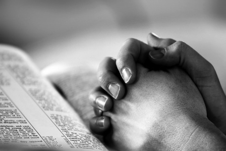 praying-hands-on-bible-black-and-white
